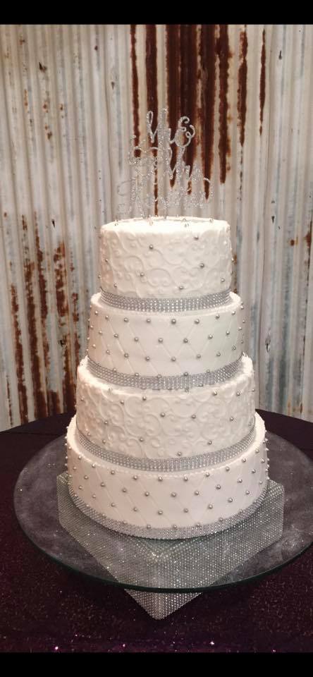 four tier wedding cake with silver accents