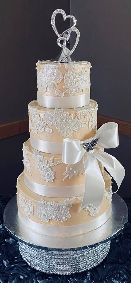 ivory wedding cake with white lace decor
