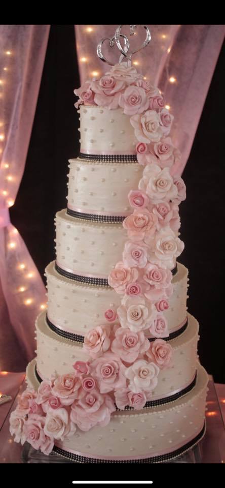 six tier wedding cake with cascading pink iced roses