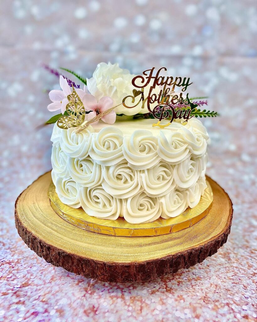 279461244_10159641836785306_9175496476196287589_n mother's day vake with rosettes and purple flowers