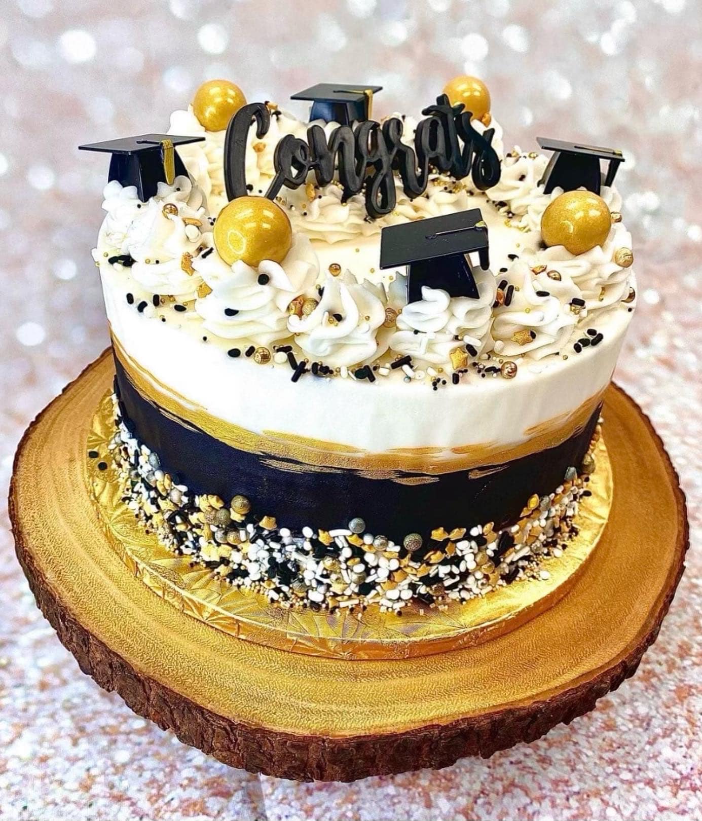 black, white, and gold graduation cake