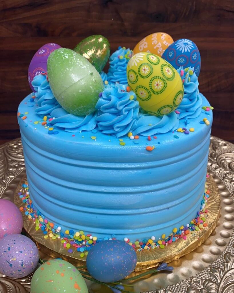 339823741_932233038040805_2845923860062436644_n blue Easter cake topped with Easter Eggs