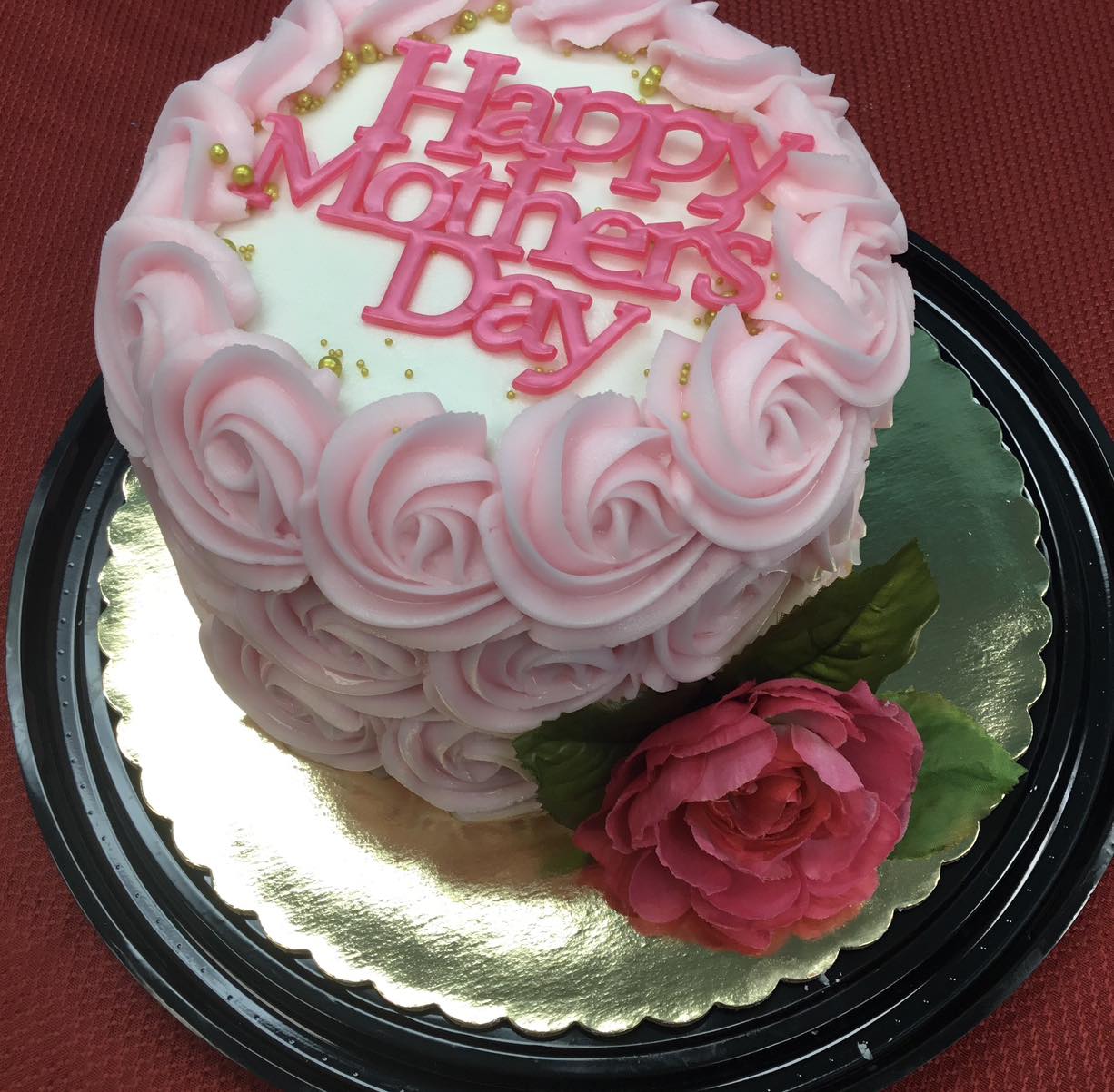 Mother's Day cake with pink flower and pink rosettes